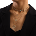 Gold-tone layered necklace with crystal cross pendant