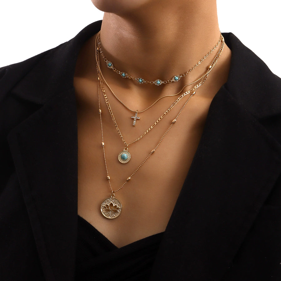 Gold-tone layered necklace with crystal cross pendant